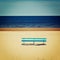 Blue bench on the empty beach - vintage photo. Picnic bench and spring seascape - retro filter.