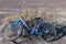 A blue bicycle abandoned in the desert