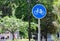 Blue bicycle lane sign with trees background