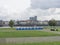 Blue bio toilets on the green embankment of the river