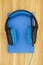 Blue and black headset with microphone with a book