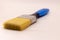 Blue and black paint brush isolated in white background blurry focus.