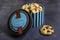 Blue and black striped box with delicious cookies on a dark gray background