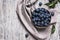 Blue blackthorn berries in metallic bowl on a table