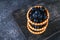 Blue blackthorn berries in sand tartlets on a table.