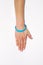 Blue blank rubber wristband on wrist arm. Silicone fashion round social bracelet wear hand. Unity band.