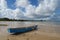 Blue boat, on beautiful blue sky and cotton-clouds background at Ponta do Muta, Barra Grande, Marau Peninsula, Bahia State, Brazil