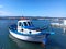 Blue boat in the blue sea water. Harbor landscape, transportation