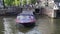 Blue Boat Canal Cruise Ship with tourists on touring the canals through city, boat