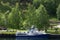 Blue boat in a harbor with trees in the background Flam, Narrow Fjord, Vestland county, Norway