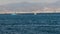 Blue boat and a sailboat sailing in the Gulf of Izmir