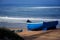 Blue boats of fishermen on the shore against the background of the Atlantic ocean