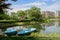 Blue boats at lakeside near city in sunny summer morning