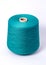 Blue bobbin of yarn on a white background.Textile reel on isolated white background