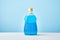 a blue bottle of fabric softener with a plain background