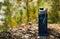 A blue bottle with a healthy drink is convenient to take on a hike.