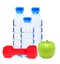 Blue bottles with water, red dumbell and green apple isolated