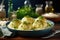 A blue bowl filled with dumplings covered in cheese. Potato dumplings, german dish.