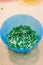 Blue bowl full of green leds for educational activities for children. STEM education at school