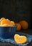 A blue bowl of orange tangerine segments