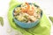 Blue bowl of rice and shrimps and vegetables