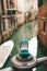 A blue box with engagement ring stands on the bridge mount front venetian canal. An offer of marriage in Venice, Italy