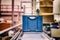 Blue boxes in a large, fully automated logistics warehouse run on a conveyor belt. Background is blurred. It is a modern storage