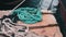 Blue bright fishing gear lying at pier. Close up of mooring ropes. Fishing equipment at marina. Close up view of fish-tackle. Boat