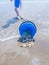 Blue bucket tipped over on beach