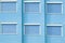 Blue Building Facade with Six Closed Windows Shutters