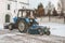 Blue bulldozer cleans the streets after a heavy natural snowfall. Getting ready for Christmas. Sunny frosty day. Close