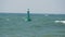 Blue buoy swings on waves in sea