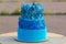 Blue buttercream birthday cake with colorful sprinkles