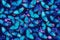 Blue butterflies and luminous flowers. Shimmering background in vibrant purple and blue shades