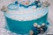 Blue cake with mastic cross and angels for boy christening party