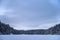 Blue calm winter landscape of a frozen lake in Repovesi National Park, Finland