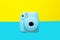 Blue camera with blank picture frames on colourful background. Fashion Film Camera. Nostalgia photography. Top view. Minimal and m
