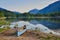 Blue canoe beside blue Buttle lake and blue mountains, BC