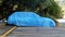 blue car cover tarpaulin on car