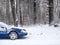 Blue car white snow snowy dry trees