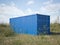 Blue cargo container in a field. 3d rendering