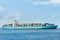 Blue cargo container ship anchored in harbor