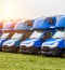 Blue cargo vans stand in a row, trucking and logistics, trucking industry