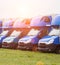 Blue cargo vans stand in a row, trucking and logistics, trucking industry and sun