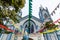 Blue Catholic church decorated with flags and Saint Mary statue