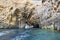 Blue Cave carved in the limestone by the Adriatic Sea, tourists sailing by boat to the grotto, Bisevo, Croatia