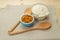 A blue ceramic bowl with almonds, a glass bowl with flour, woode