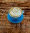 Blue ceramic cup with cappuccino.