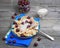 In blue ceramic dish, fruit and berry dumplings with cherries