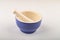 Blue ceramic spice mortar with pestle on white background. Close up